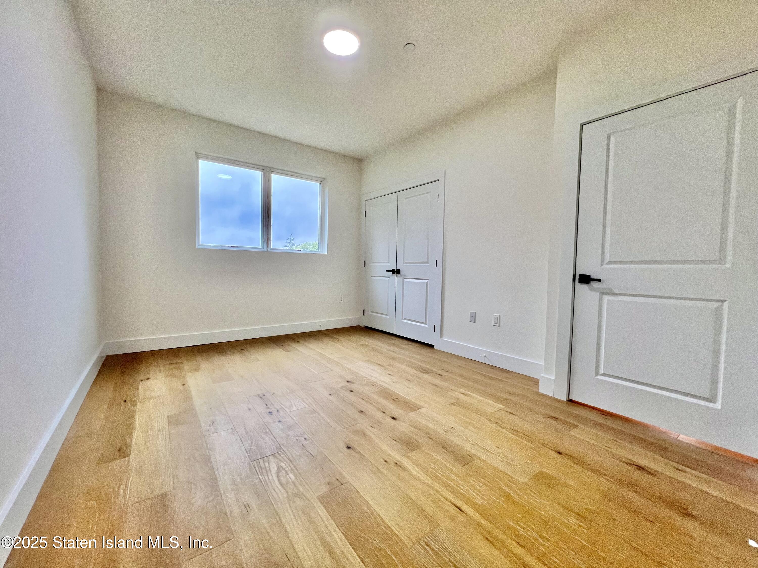 3865 Amboy Road, Unit 2G Staten Island, NY 10308 - Photo 17 of 27 a view of empty room with wooden floor