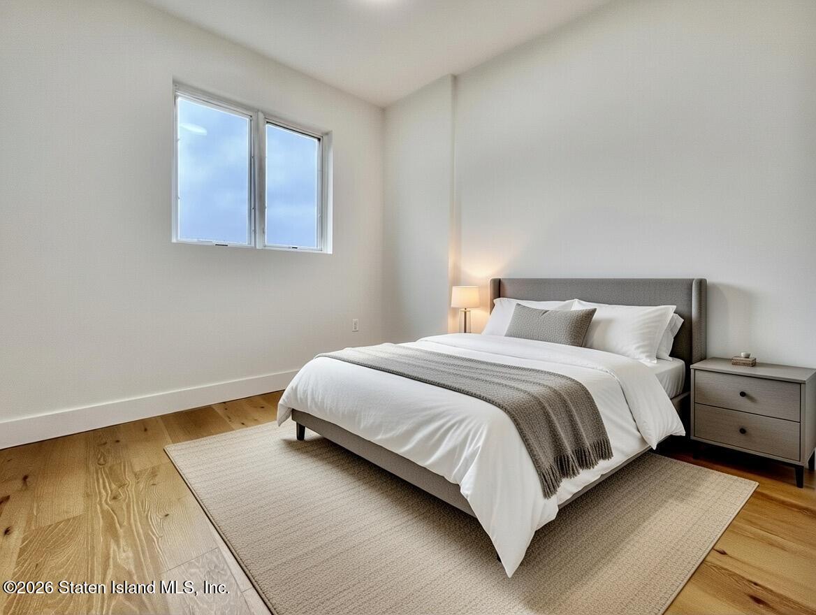 3865 Amboy Road, Unit 2G Staten Island, NY 10308 - Photo 20 of 27 a bedroom with a bed and a night stand