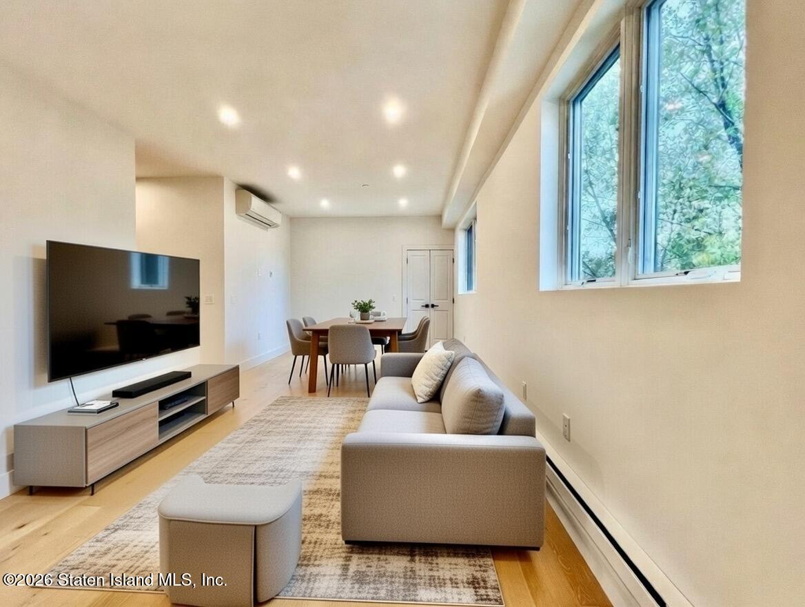 3865 Amboy Road, Unit 2G Staten Island, NY 10308 - Photo 5 of 27 a living room with furniture and a flat screen tv