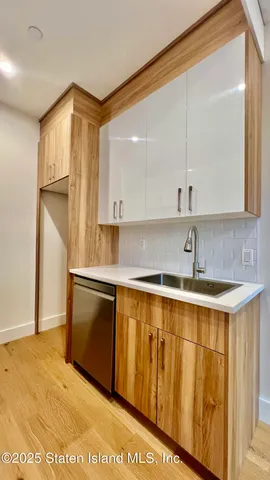 a view of a kitchen with stainless steel appliances granite countertop a sink and a cabinets