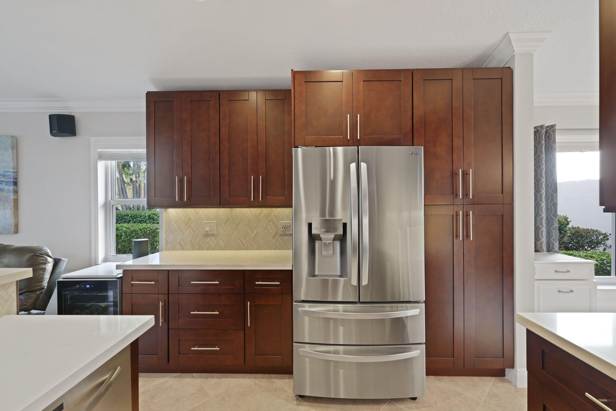 116 Cameron Drive Weston, FL 33326 - Photo 12 of 75 a kitchen with granite countertop a refrigerator and a stove top oven