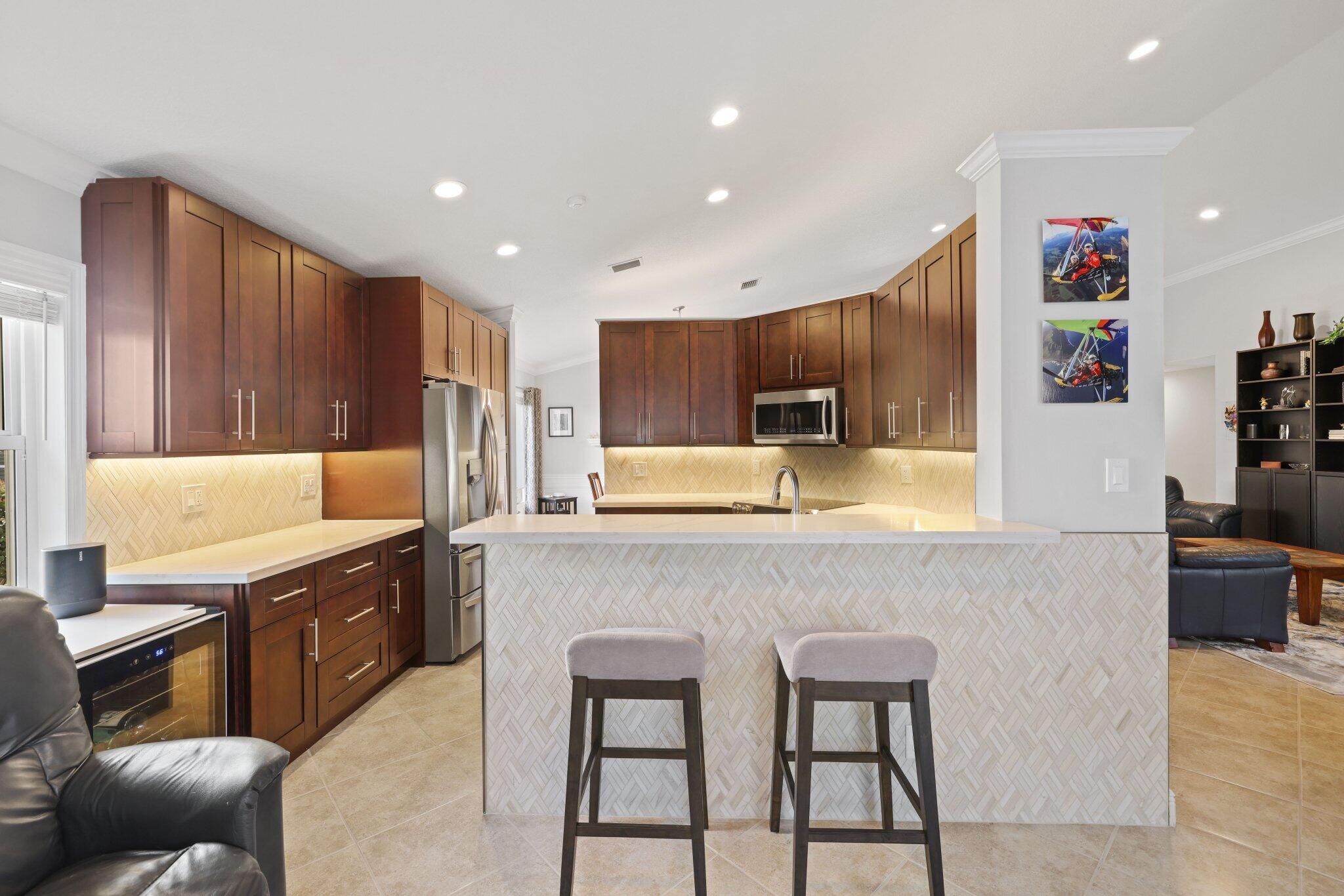 116 Cameron Drive Weston, FL 33326 - Photo 13 of 75 a large kitchen with stainless steel appliances kitchen island granite countertop a table and chairs in it