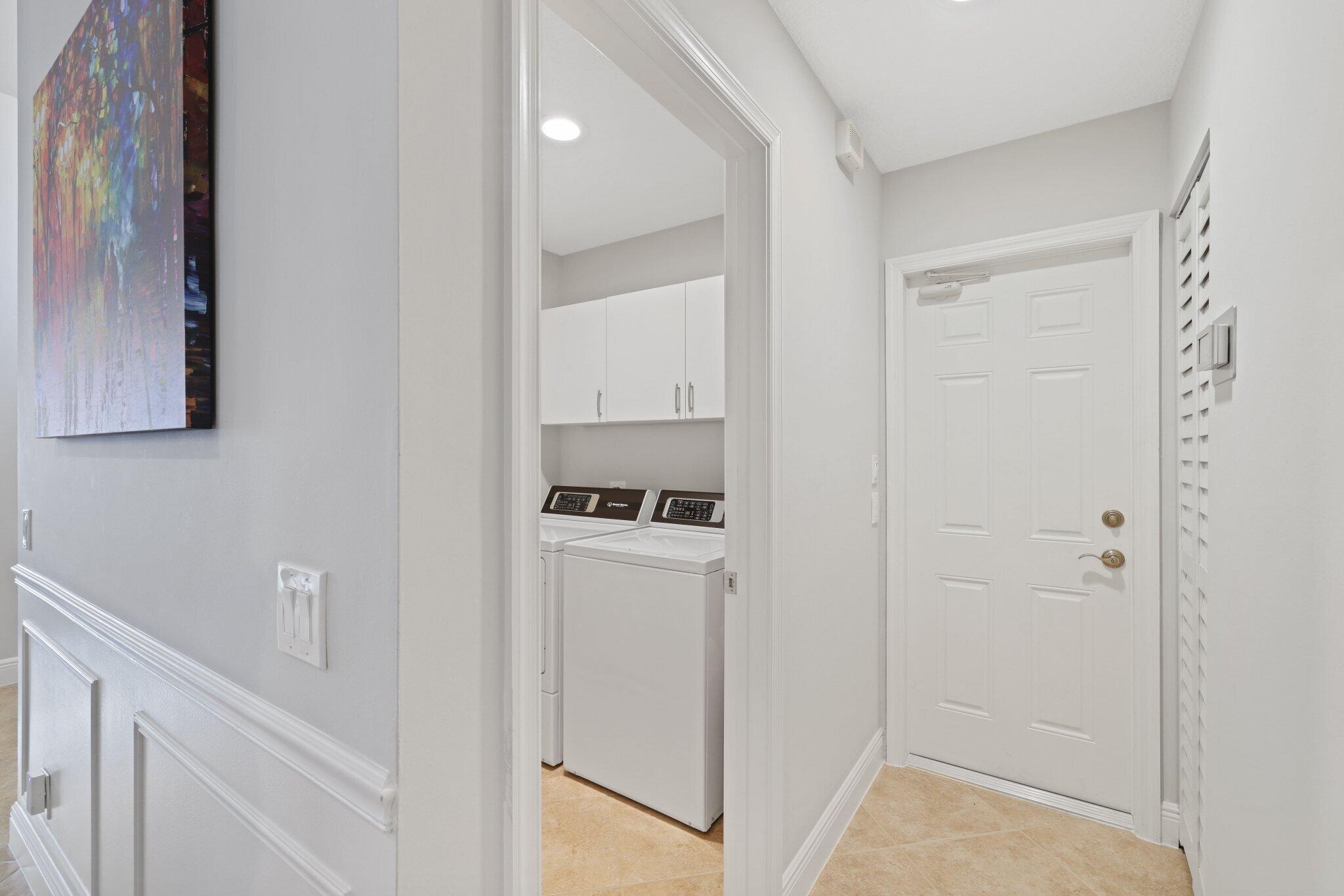 116 Cameron Drive Weston, FL 33326 - Photo 20 of 75 a kitchen with white cabinets and white appliances