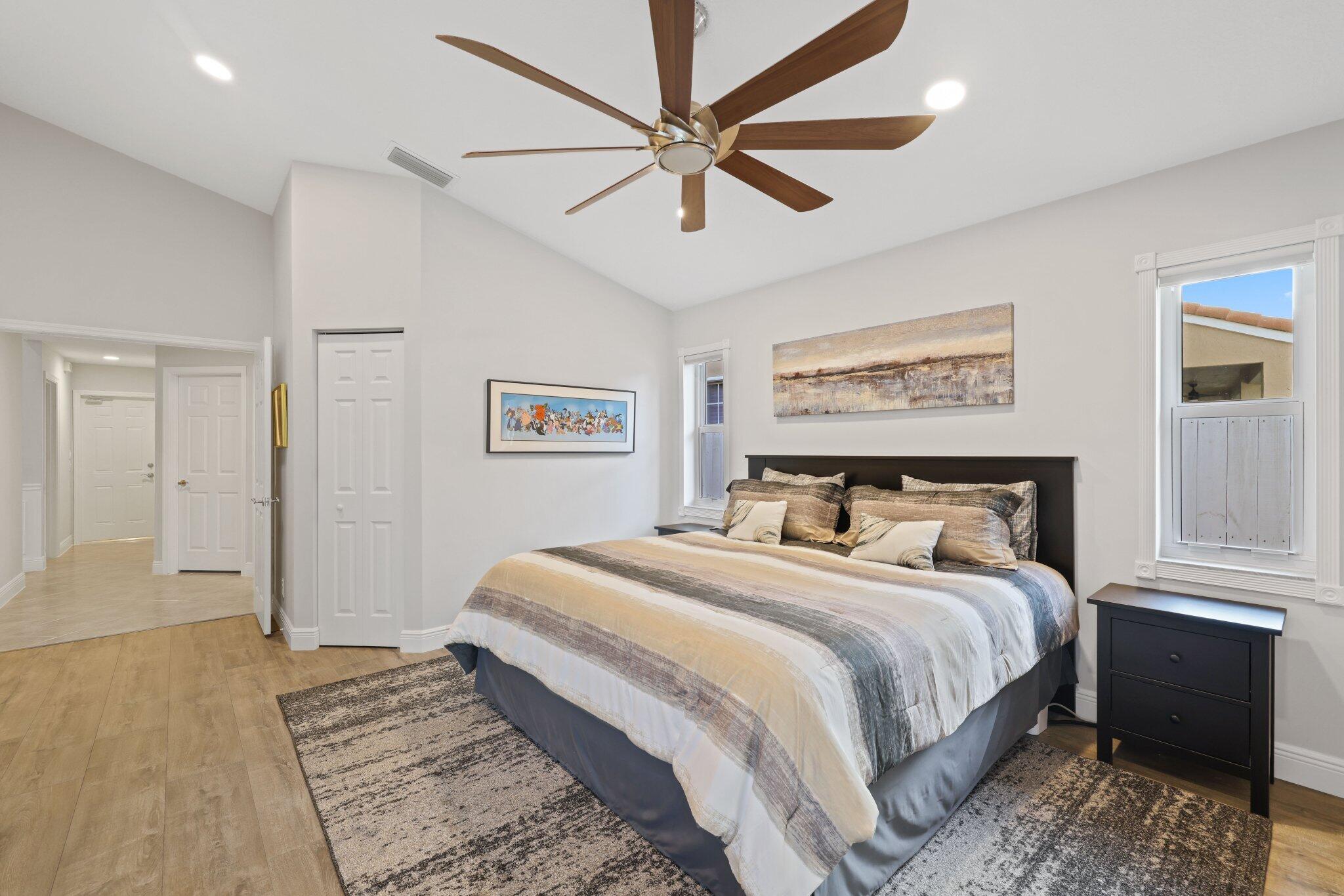 116 Cameron Drive Weston, FL 33326 - Photo 29 of 75 a bedroom with a large bed and a chandelier