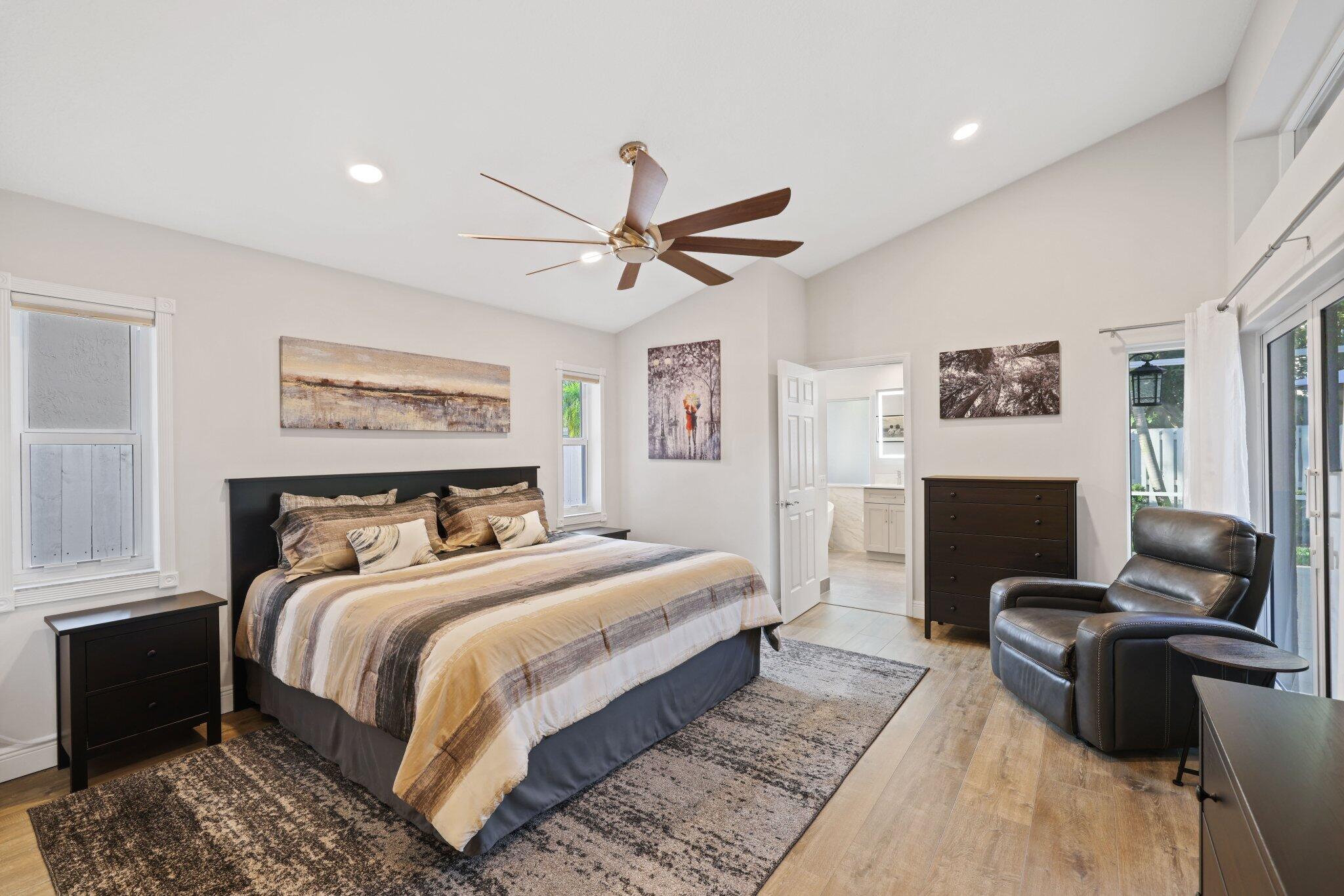 116 Cameron Drive Weston, FL 33326 - Photo 31 of 75 a bedroom with a bed a couch and a computer on a table