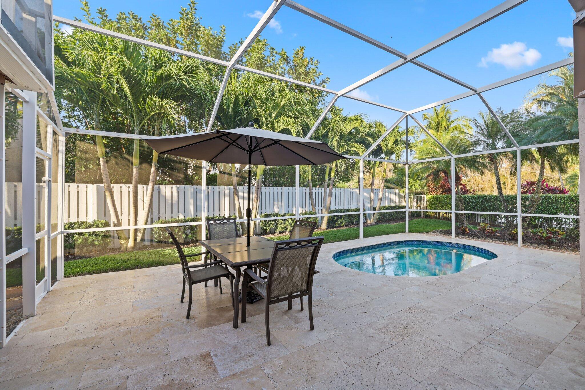 116 Cameron Drive Weston, FL 33326 - Photo 38 of 75 a view of a swimming pool with a patio and a yard