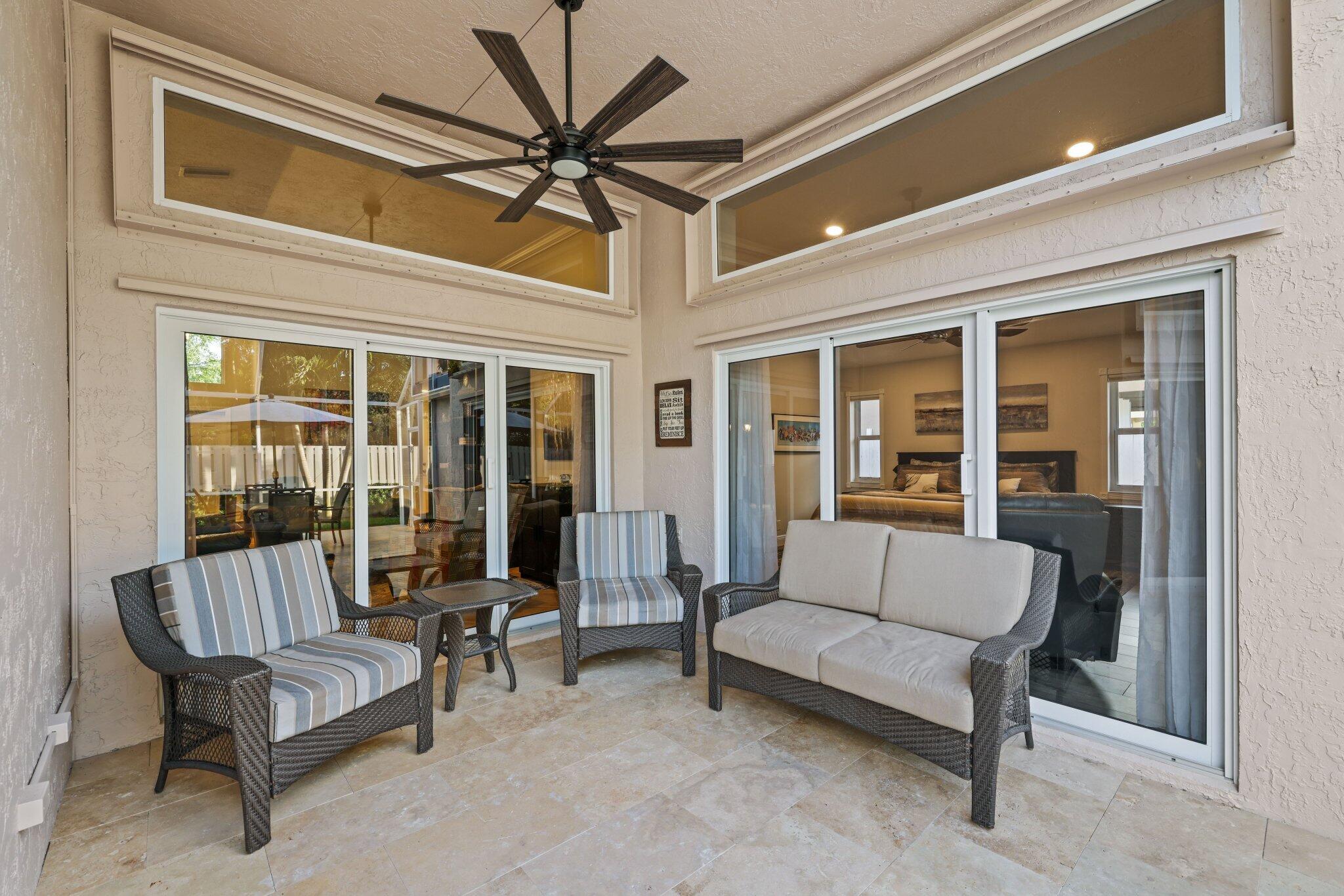 116 Cameron Drive Weston, FL 33326 - Photo 43 of 75 a balcony with furniture and a ceiling fan