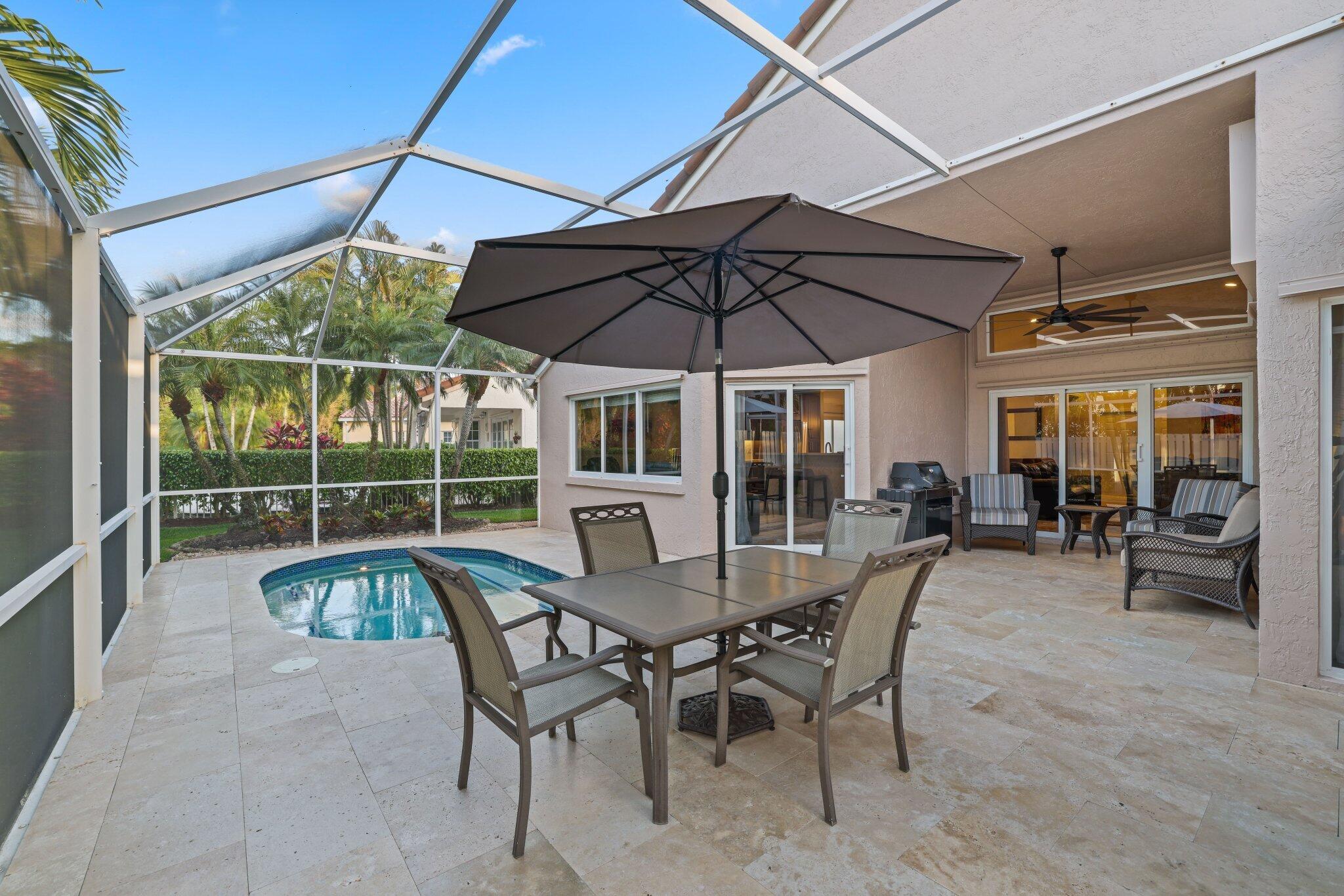 116 Cameron Drive Weston, FL 33326 - Photo 49 of 75 a view of a patio with a table and chairs under an umbrella