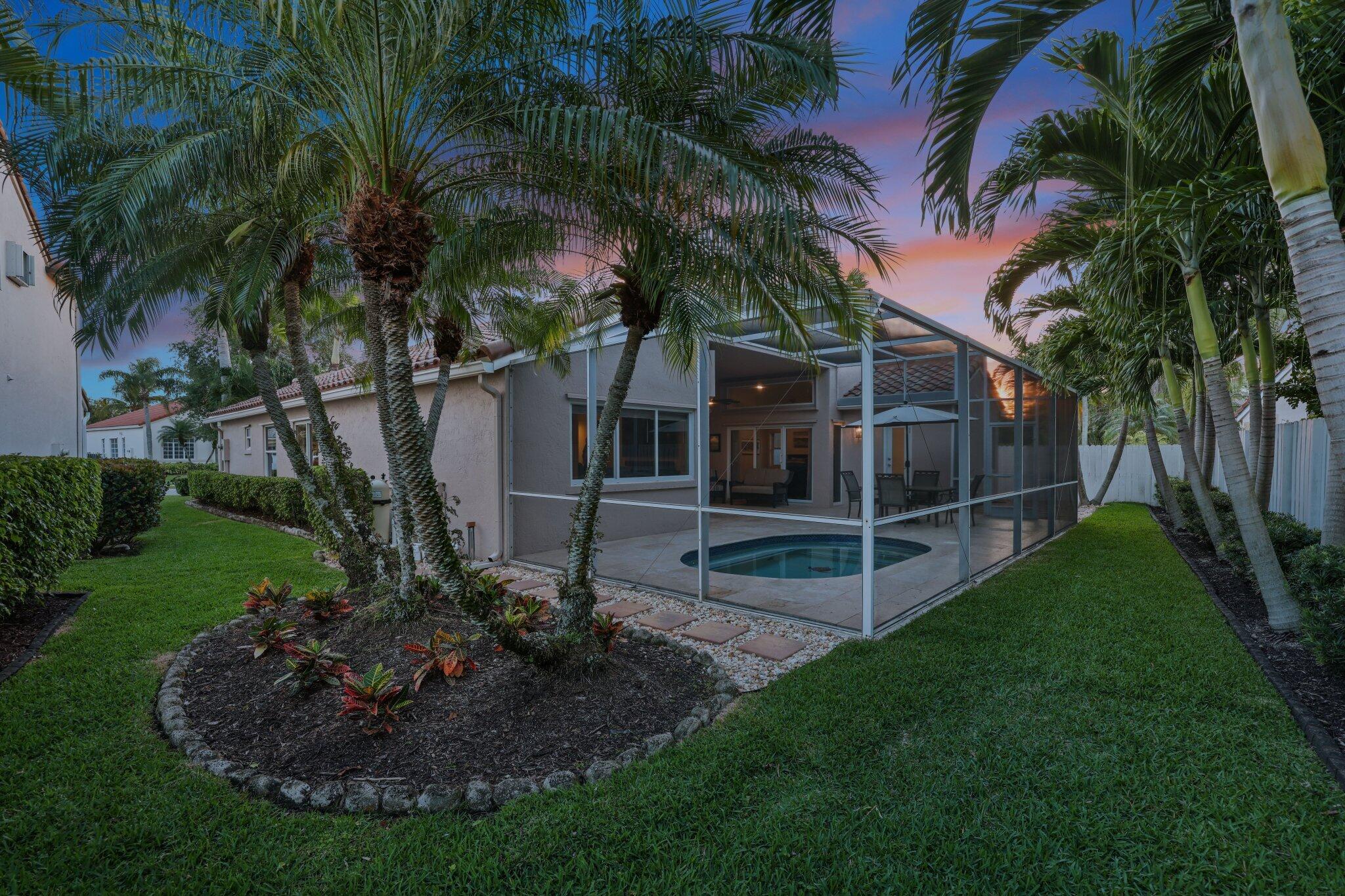 116 Cameron Drive Weston, FL 33326 - Photo 59 of 75 a view of a backyard with potted plants and large trees