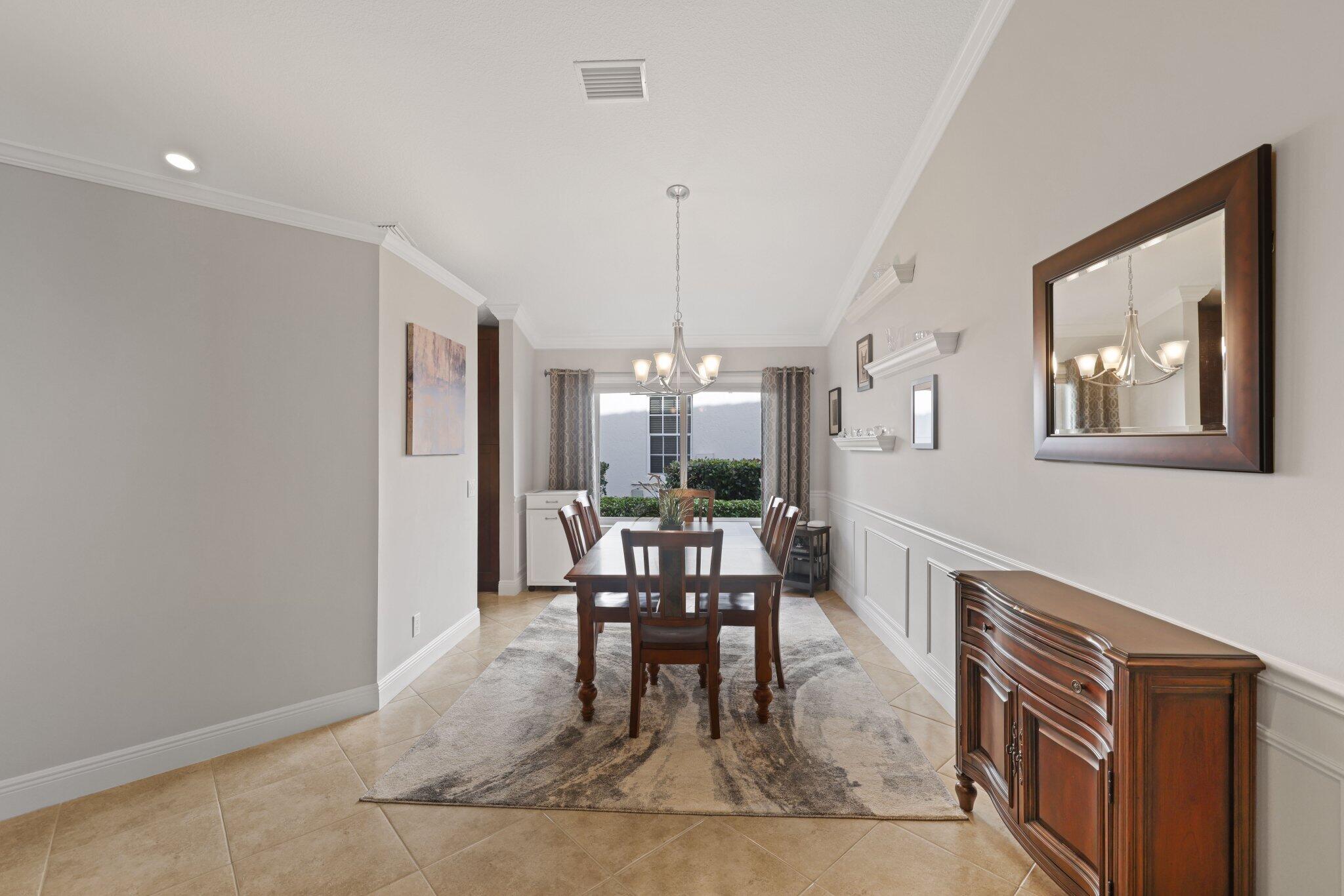 116 Cameron Drive Weston, FL 33326 - Photo 6 of 75 a dining room with furniture a rug and wooden floor