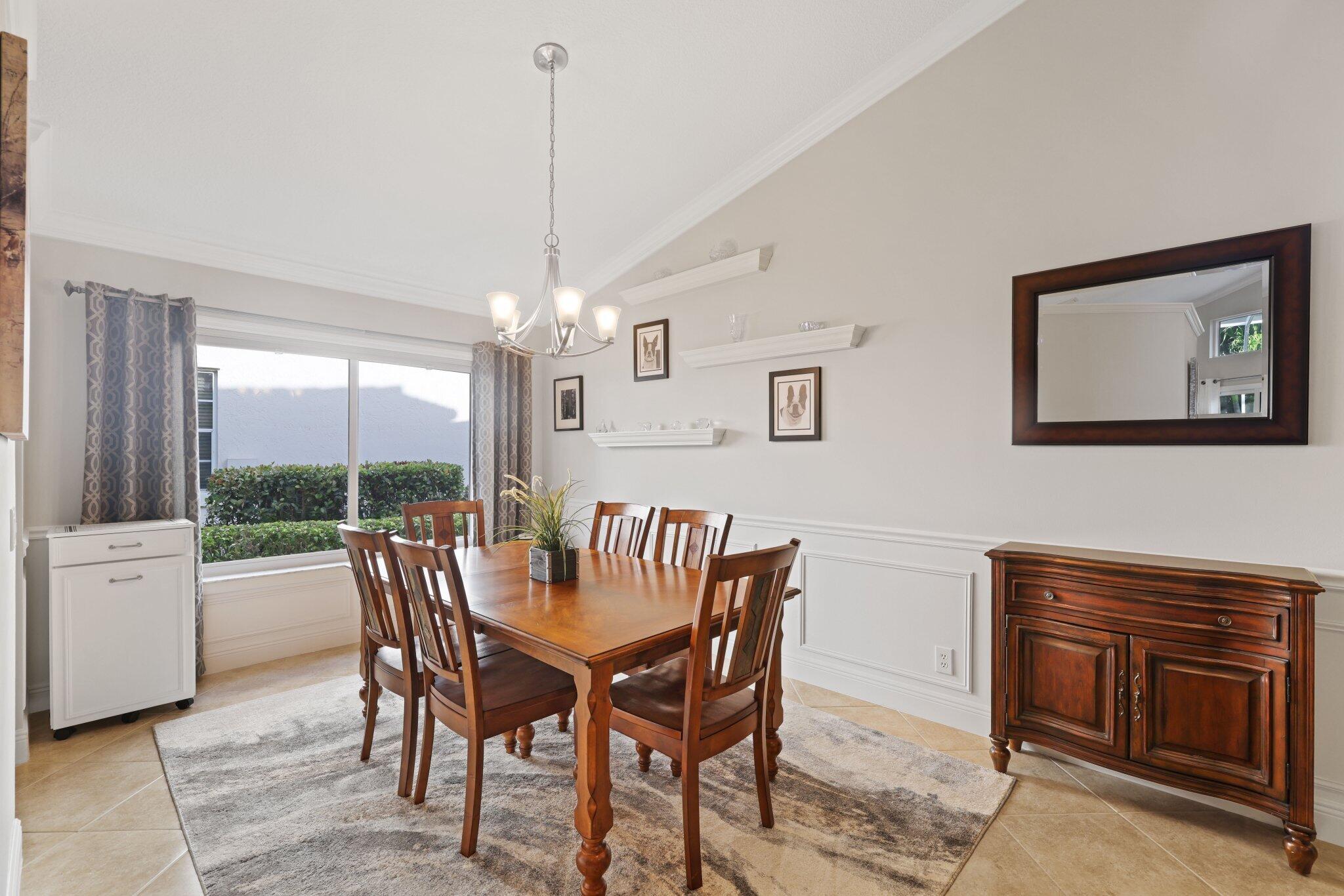 116 Cameron Drive Weston, FL 33326 - Photo 7 of 75 a dining room with furniture a chandelier and wooden floor