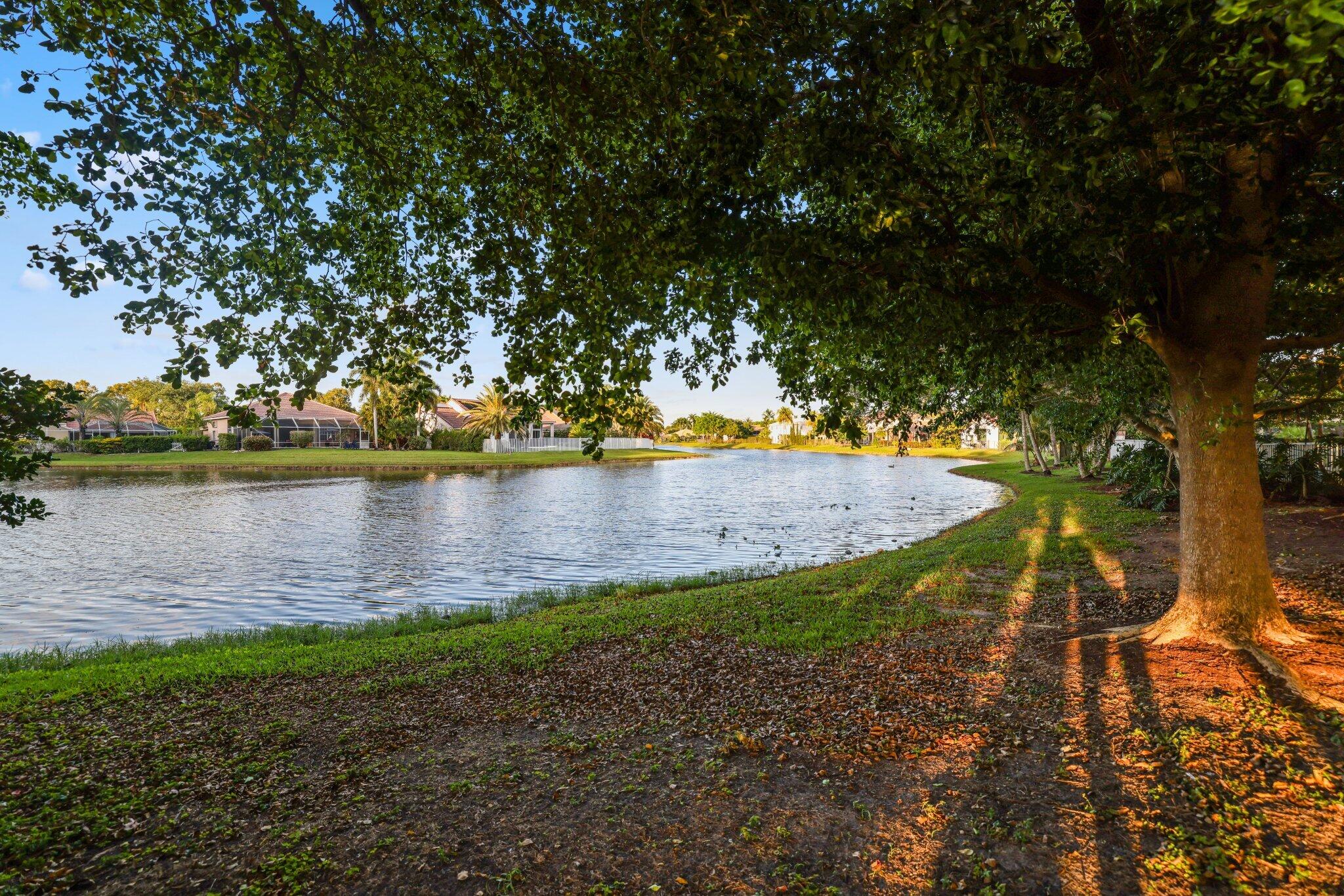 116 Cameron Drive Weston, FL 33326 - Photo 71 of 75 a view of a lake with houses in the back