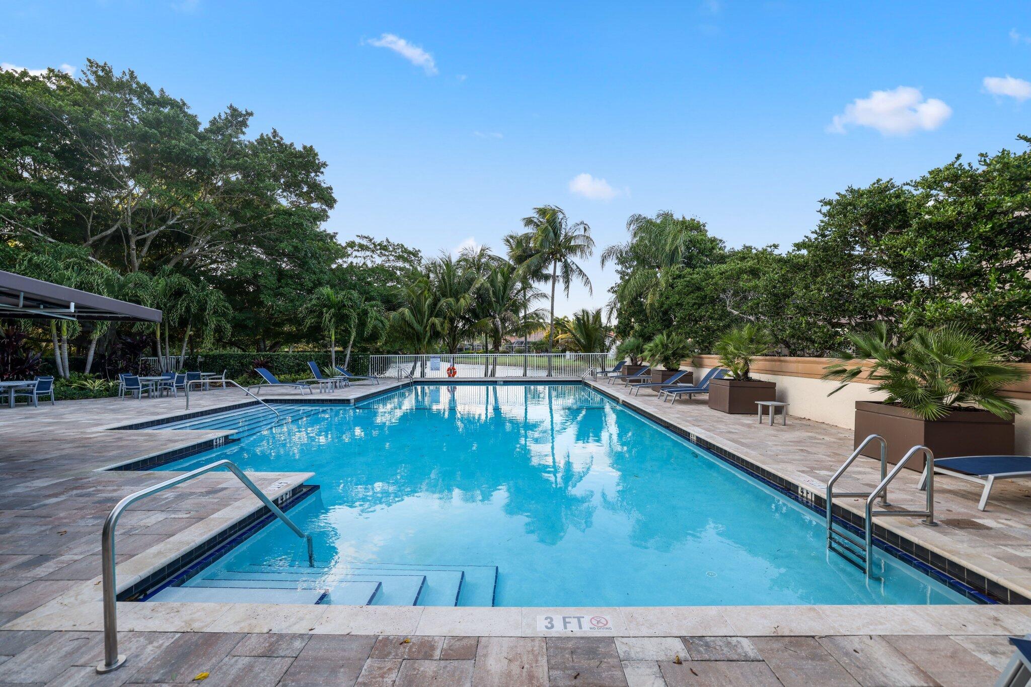 116 Cameron Drive Weston, FL 33326 - Photo 73 of 75 a view of a swimming pool with a lounge chair