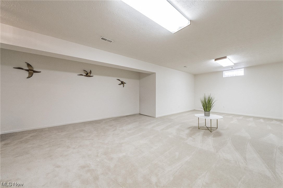 4220 Castle Ridge Akron, OH 44321 - Photo 25 of 35 Basement with light colored carpet and a textured ceiling