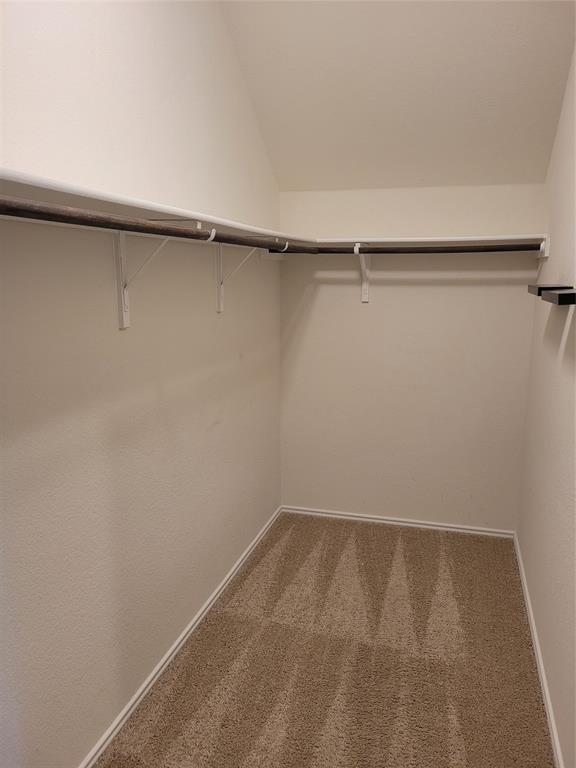 14917 Gypsum Mill Road Manor, TX 78653 - Photo 25 of 28 A well-organized closet space provides ample storage with integrated shelving and hanging rods.