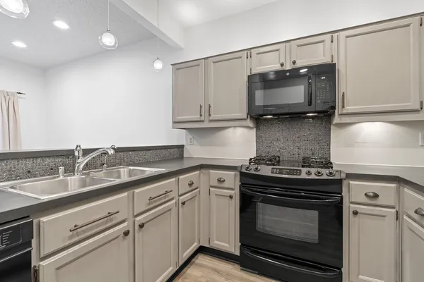 a kitchen with a stove and a microwave