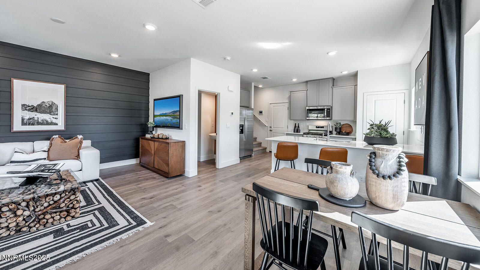 5857 Morgan Horse Street Reno, NV 89523 - Photo 3 of 23 a kitchen with stainless steel appliances granite countertop a stove top oven a sink a dining table and chairs