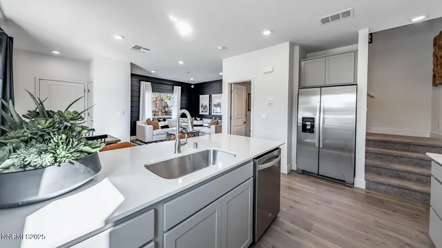 a kitchen with kitchen island a counter top space a sink and refrigerator