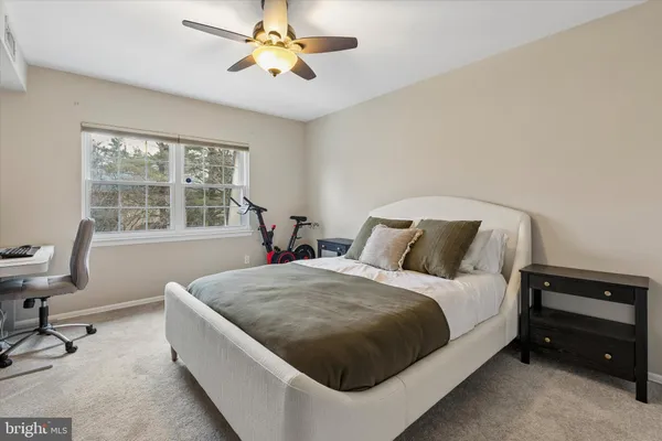 a bedroom with a bed and a desk