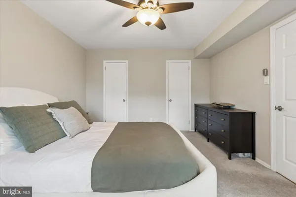 a bed room with a bed and a ceiling fan