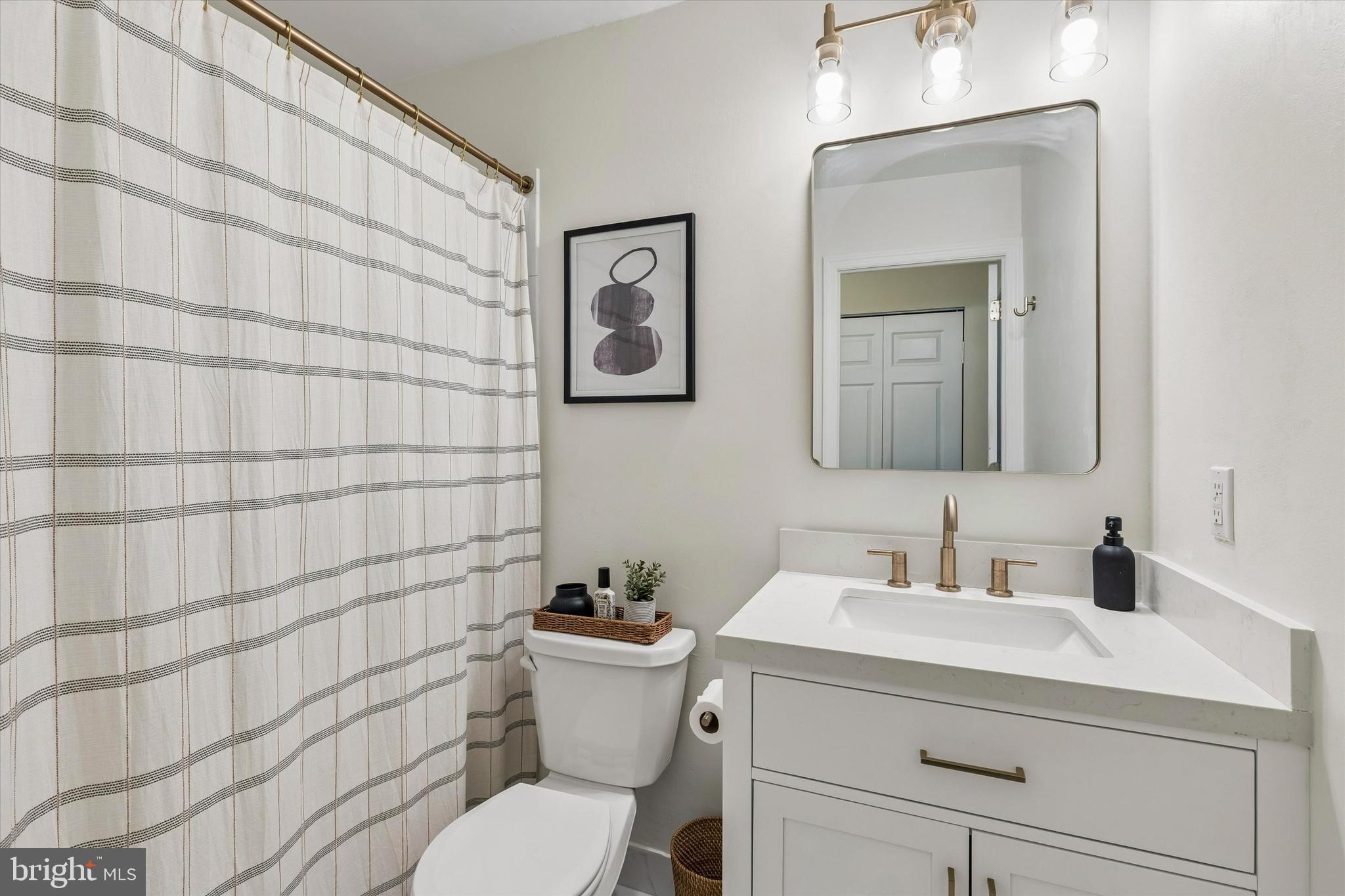 437 Old Forge Crossing, Unit 437 Devon, PA 19333 - Photo 15 of 22 a bathroom with a toilet sink and mirror