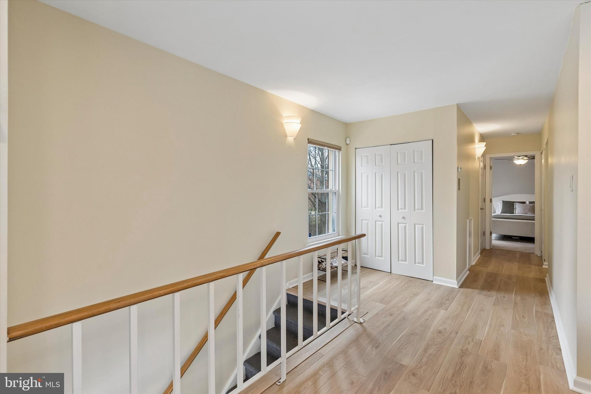 437 Old Forge Crossing, Unit 437 Devon, PA 19333 - Photo 3 of 22 a view of a hallway with wooden floor and staircase