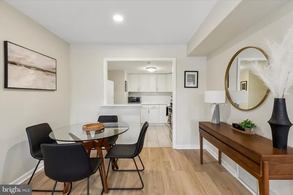 a view of a dining room with furniture and a potted plant