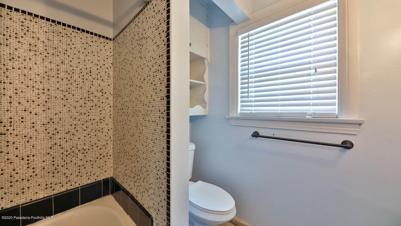 11364 Lambert Avenue El Monte, CA 91732 - Photo 23 of 39 a bathroom with a toilet and a shower curtain