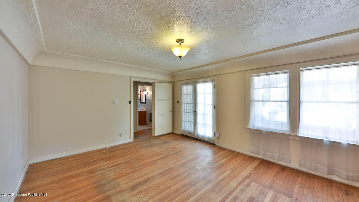 11364 Lambert Avenue El Monte, CA 91732 - Photo 6 of 39 an empty room with wooden floor and windows
