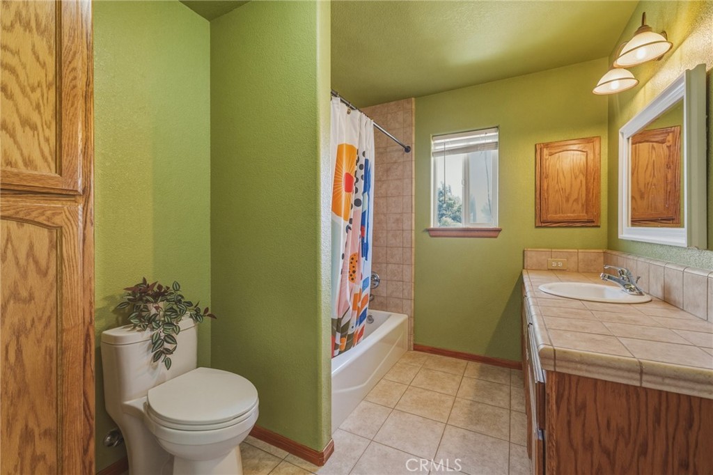 19501 Kinai Road Apple Valley, CA 92307 - Photo 33 of 49 a bathroom with a granite countertop toilet sink and mirror