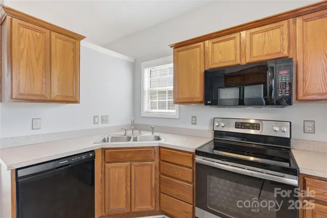 a kitchen with a sink stove and microwave
