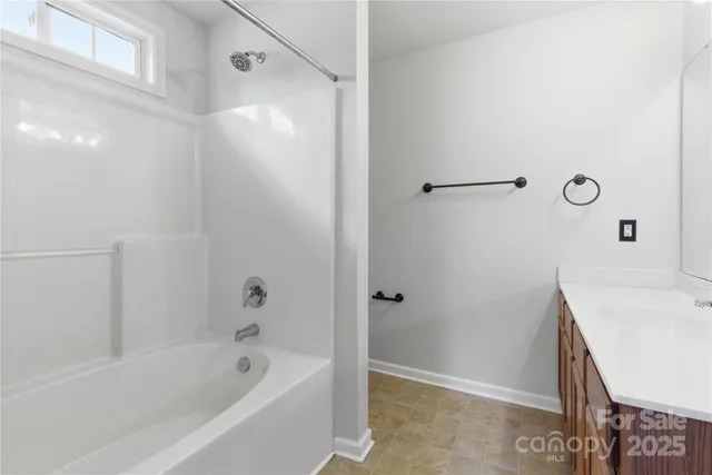 a bathroom with a bathtub and a sink