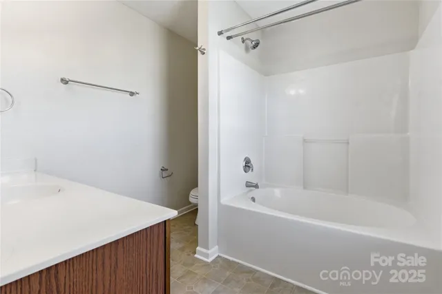a white bath tub sitting next to a white sink