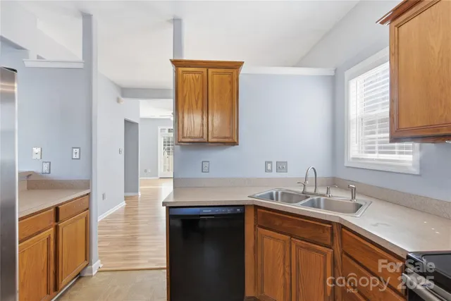 a kitchen with stainless steel appliances granite countertop a sink stove and cabinets