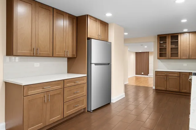 a kitchen with stainless steel appliances granite countertop a refrigerator and a stove