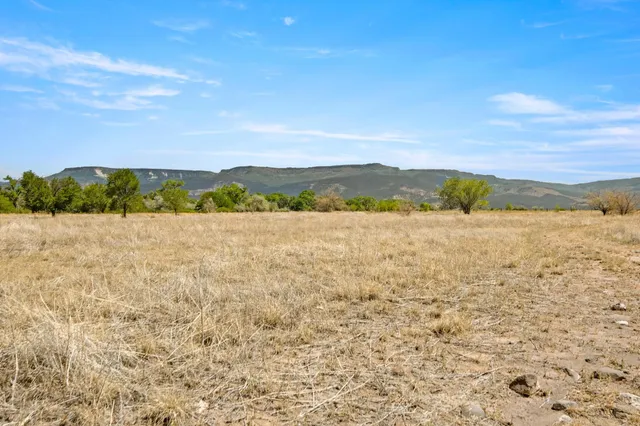 an aerial view of ocean and residential houses with outdoor space