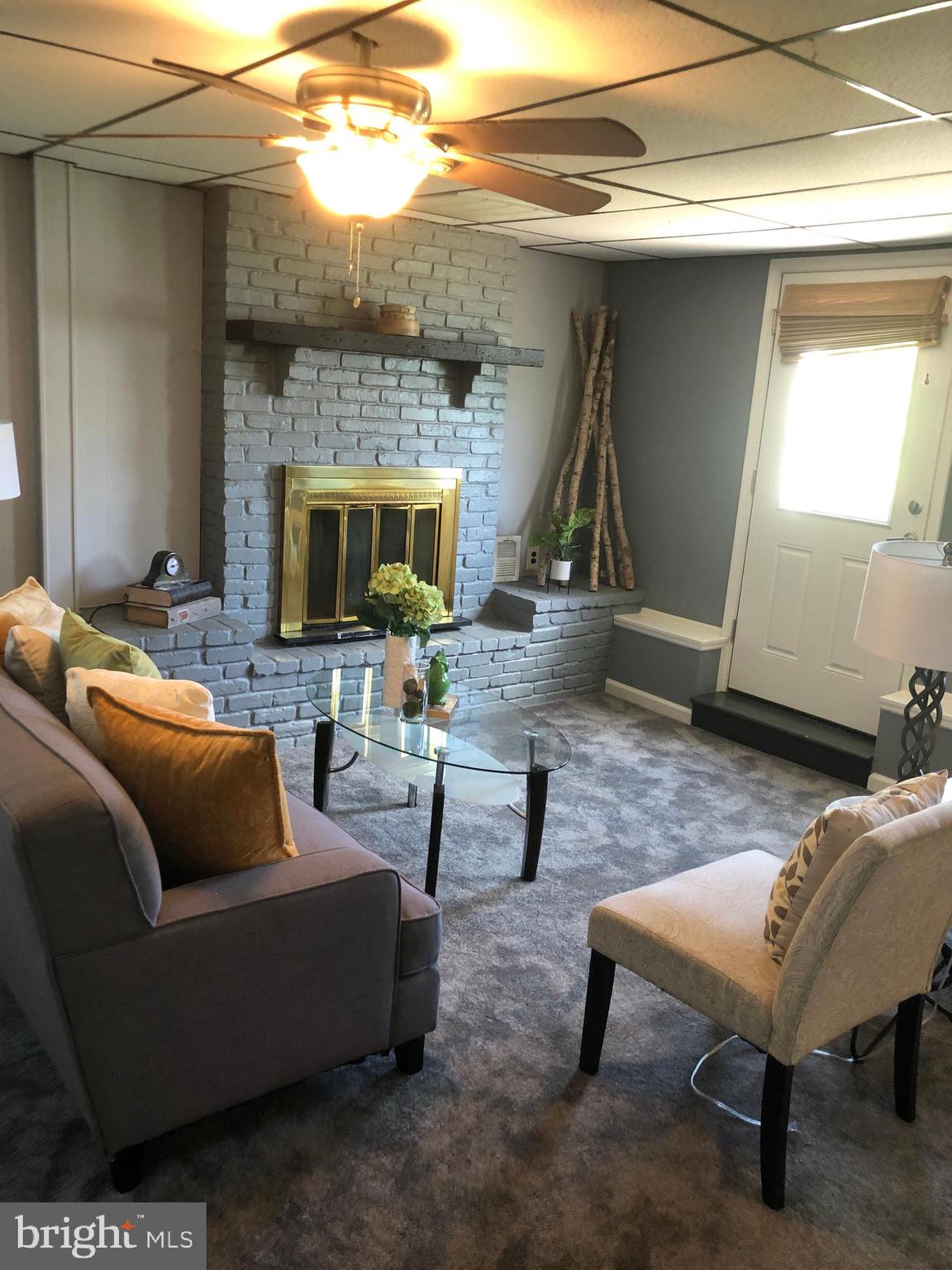 1006 Stane Road Glen Burnie, MD 21060 - Photo 24 of 44 Family room with brick fireplace and new carpet