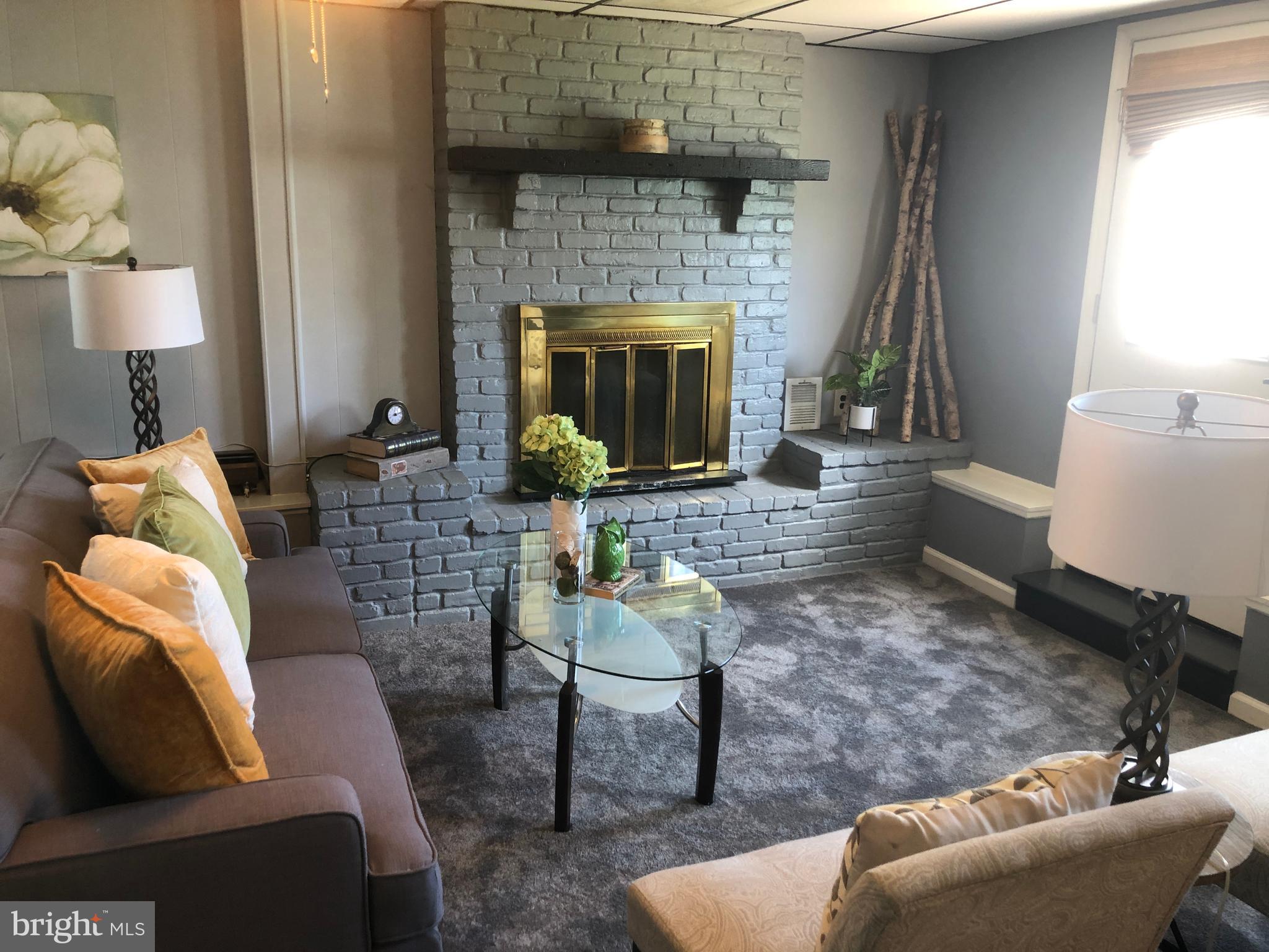 1006 Stane Road Glen Burnie, MD 21060 - Photo 25 of 44 Family room with brick fireplace and new carpet