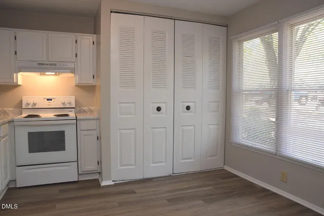 a view of a kitchen with a stove cabinets and wooden floor