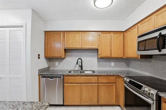 a view of washer and dryer with kitchen in the background