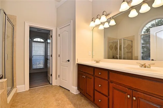 a bathroom with a double vanity sink and a mirror