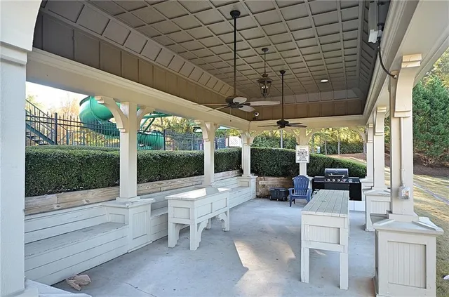 a building outdoor space with patio furniture and garden view