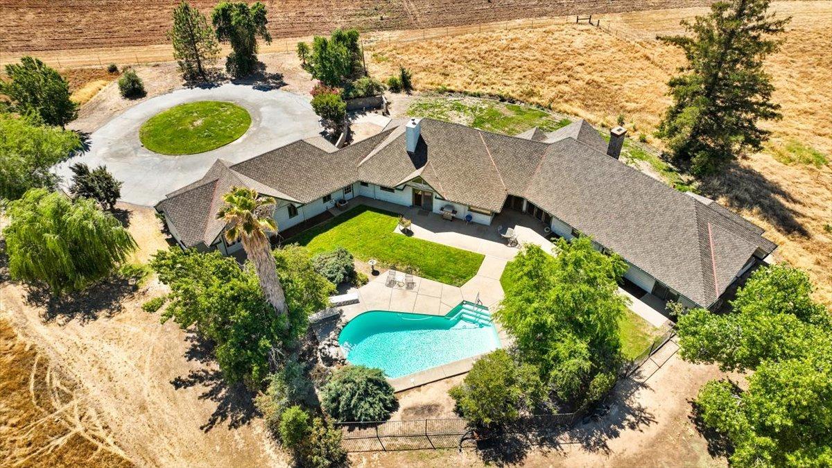 an aerial view of a house having yard swimming pool and outdoor seating