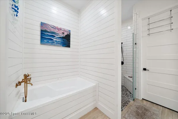 a spacious bathroom with a granite countertop sink mirror and bathtub