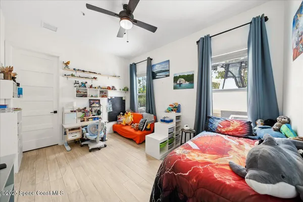 a en suite bathroom with a granite countertop sink and a mirror