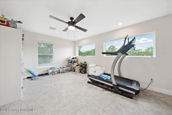 a bathroom with a granite countertop toilet sink and mirror