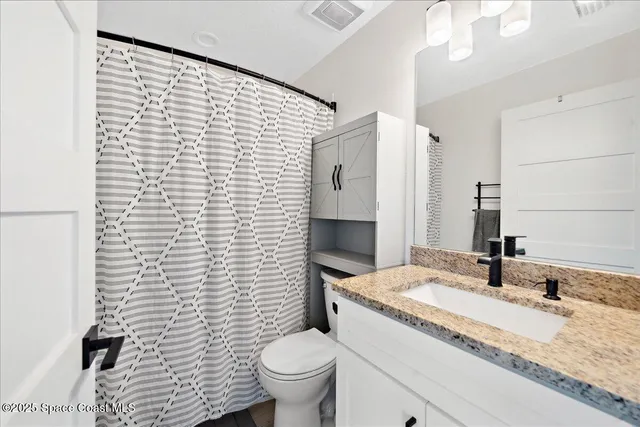 a view of a house with a backyard and a tree