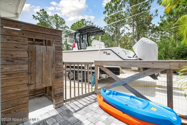 a kitchen with stainless steel appliances granite countertop a refrigerator a stove and a dining table with wooden floor