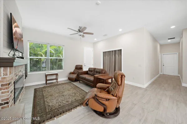 a view of backyard with potted plants and large tree