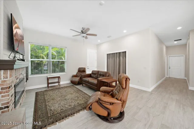 a view of backyard with potted plants and large tree